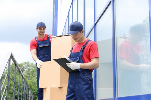 Professional movers wrapping furniture for transport