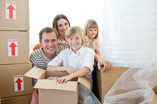 Local movers handling a sofa and large items in a Richmond area property